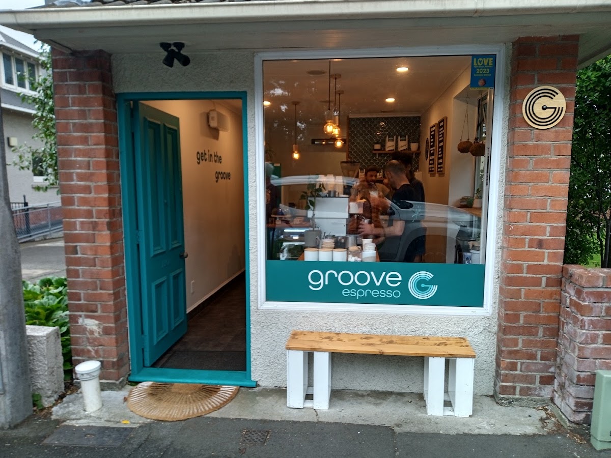 The Groove Espresso shopfront on Kelvin Street with its teal door and window signage